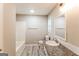 Well-lit bathroom featuring a granite countertop, updated sink fixtures, and a shower-tub combo at 2730 Pine Log Way, Buford, GA 30519