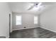 Primary bedroom featuring laminate flooring, two windows, and a ceiling fan at 2730 Pine Log Way, Buford, GA 30519