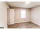 Neutral bedroom featuring sleek, wood-look flooring, an updated light fixture, and bright window at 2730 Pine Log Way, Buford, GA 30519