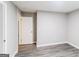 Neat bedroom with wood-look flooring and neutral walls; open doorway to an adjacent room at 2730 Pine Log Way, Buford, GA 30519