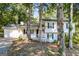 View of two-story home with white exterior, dark shutters and a quaint covered porch at 2730 Pine Log Way, Buford, GA 30519