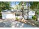 Charming two-story home with white exterior, front porch, attached garage and mature trees at 2730 Pine Log Way, Buford, GA 30519