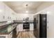 Kitchen area showcasing updated stainless appliances and granite countertops at 2730 Pine Log Way, Buford, GA 30519