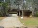 Charming single-Gathering home with a two-car garage surrounded by mature trees and an extended driveway at 3208 Berrong Way, Stone Mountain, GA 30087