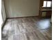 Open floor plan with hardwood floors leading to a kitchen and sliding glass doors to the exterior at 3208 Berrong Way, Stone Mountain, GA 30087