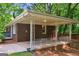 Charming brick home showcasing a cozy covered back porch and fenced-in yard at 1749 Creat Se Trl, Smyrna, GA 30080