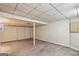 Spacious unfinished basement with carpet, white support beam, and drop ceiling at 1749 Creat Se Trl, Smyrna, GA 30080