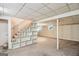 Large, carpeted basement featuring staircase with built-in shelving and paneled ceiling at 1749 Creat Se Trl, Smyrna, GA 30080