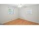 Empty bedroom with hardwood floors and two bright windows and a ceiling fan at 1749 Creat Se Trl, Smyrna, GA 30080