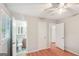 Bedroom with hardwood floors, beige walls, a ceiling fan and an ensuite bathroom at 1749 Creat Se Trl, Smyrna, GA 30080