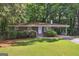 Charming brick home features lush green lawn, mature trees, and a convenient carport at 1749 Creat Se Trl, Smyrna, GA 30080