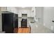 Traditional style kitchen features granite countertops, wood floors and updated black appliances at 1749 Creat Se Trl, Smyrna, GA 30080