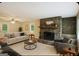 Comfortable living room featuring a stone fireplace, a cozy sofa, and natural light at 1749 Creat Se Trl, Smyrna, GA 30080