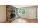 Living room showcasing a stone fireplace, hardwood floors, and a bright, airy atmosphere at 1749 Creat Se Trl, Smyrna, GA 30080