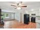 Open-concept space showcasing hardwood floors, a fireplace, and an eat-in kitchen with white cabinets at 1749 Creat Se Trl, Smyrna, GA 30080