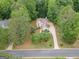 Aerial shot of a beautiful home surrounded by mature trees, showcasing its private lot and curb appeal at 215 Barrington Grange Dr, Sharpsburg, GA 30277