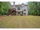 Spacious home backyard featuring a well-maintained lawn, back deck and mature trees at 215 Barrington Grange Dr, Sharpsburg, GA 30277