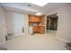 Finished basement featuring a kitchenette with wood cabinets, and a door for storage or utility access at 215 Barrington Grange Dr, Sharpsburg, GA 30277