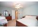 Bedroom with a ceiling fan, door to the en suite bath, and carpet flooring at 215 Barrington Grange Dr, Sharpsburg, GA 30277