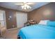 Carpeted bedroom featuring a ceiling fan and a view of the closet and open door at 215 Barrington Grange Dr, Sharpsburg, GA 30277