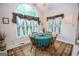 Bright breakfast nook featuring a large arch window, and a round wooden table at 215 Barrington Grange Dr, Sharpsburg, GA 30277