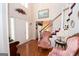 Inviting foyer with hardwood floors, staircase, and decorative accents creating a warm entrance at 215 Barrington Grange Dr, Sharpsburg, GA 30277
