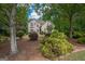 Two-story home showcasing manicured landscaping, mature trees, and architectural details at 215 Barrington Grange Dr, Sharpsburg, GA 30277