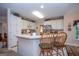 Kitchen featuring white cabinets, stainless steel appliances, and a breakfast bar with seating at 215 Barrington Grange Dr, Sharpsburg, GA 30277