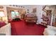 Spacious living room featuring a piano, staircase, and dining area at 215 Barrington Grange Dr, Sharpsburg, GA 30277