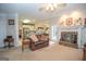Open-concept living room with fireplace, view to kitchen, and plenty of natural light at 215 Barrington Grange Dr, Sharpsburg, GA 30277