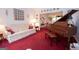Cozy living room featuring a piano and floral sofa at 215 Barrington Grange Dr, Sharpsburg, GA 30277