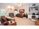 Comfortable living room with fireplace, built-in shelves, and cozy furnishings at 215 Barrington Grange Dr, Sharpsburg, GA 30277