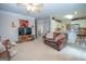 Open-concept living room flowing into the kitchen area, perfect for entertaining at 215 Barrington Grange Dr, Sharpsburg, GA 30277