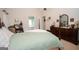 Relaxing main bedroom featuring a four poster bed, vintage furniture, and en-suite bath at 215 Barrington Grange Dr, Sharpsburg, GA 30277