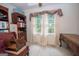 Room with built-in shelving, and a ceiling fan; filled with natural light from the window at 215 Barrington Grange Dr, Sharpsburg, GA 30277