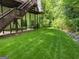 Manicured lawn leads from the back porch to a beautifully wooded back yard at 4710 Kinsmon Pl, Marietta, GA 30062