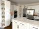 Modern kitchen with a large center island, stainless steel appliances, and custom white cabinetry at 4710 Kinsmon Pl, Marietta, GA 30062