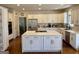 This eat-in kitchen features white cabinets, an island, and stainless appliances at 4710 Kinsmon Pl, Marietta, GA 30062