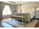 Spacious main bedroom features an area rug and light-filled windows at 4710 Kinsmon Pl, Marietta, GA 30062