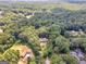 Scenic aerial view of a home on a large lot surrounded by dense trees and neighboring houses at 95 Fern Ct, Stockbridge, GA 30281
