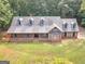 Aerial shot of brick home showcasing the yard and landscaping on a sunny day at 95 Fern Ct, Stockbridge, GA 30281