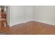Bright bedroom with wood floors, white trim, and closet storage at 95 Fern Ct, Stockbridge, GA 30281