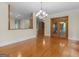 Open-concept dining area featuring hardwood floors, elegant lighting, and outdoor access to deck at 95 Fern Ct, Stockbridge, GA 30281