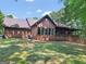 Charming brick home features a covered porch and lush, mature landscaping; inviting outdoor living at 95 Fern Ct, Stockbridge, GA 30281