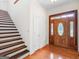 Elegant foyer featuring hardwood floors, a staircase, and a striking front door with decorative glass at 95 Fern Ct, Stockbridge, GA 30281