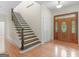 Grand entryway boasting hardwood floors, a statement staircase, and a beautifully crafted front door at 95 Fern Ct, Stockbridge, GA 30281