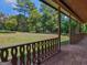 Spacious porch featuring brick flooring and intricate railing, overlooking the beautiful and well-maintained property at 95 Fern Ct, Stockbridge, GA 30281