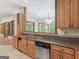 Functional kitchen with wood cabinets, stainless steel appliances, and a tile floor at 95 Fern Ct, Stockbridge, GA 30281