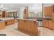 Open kitchen featuring wood cabinets, an island, and views into the adjacent dining and living areas at 95 Fern Ct, Stockbridge, GA 30281