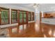 Spacious living room featuring hardwood floors, large windows, and a view of the outdoor greenery at 95 Fern Ct, Stockbridge, GA 30281